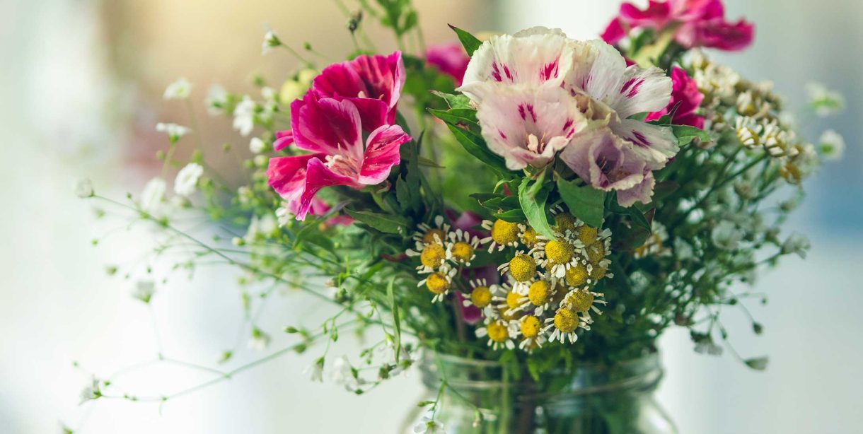 Fresh-cut flowers in a mason jar vase