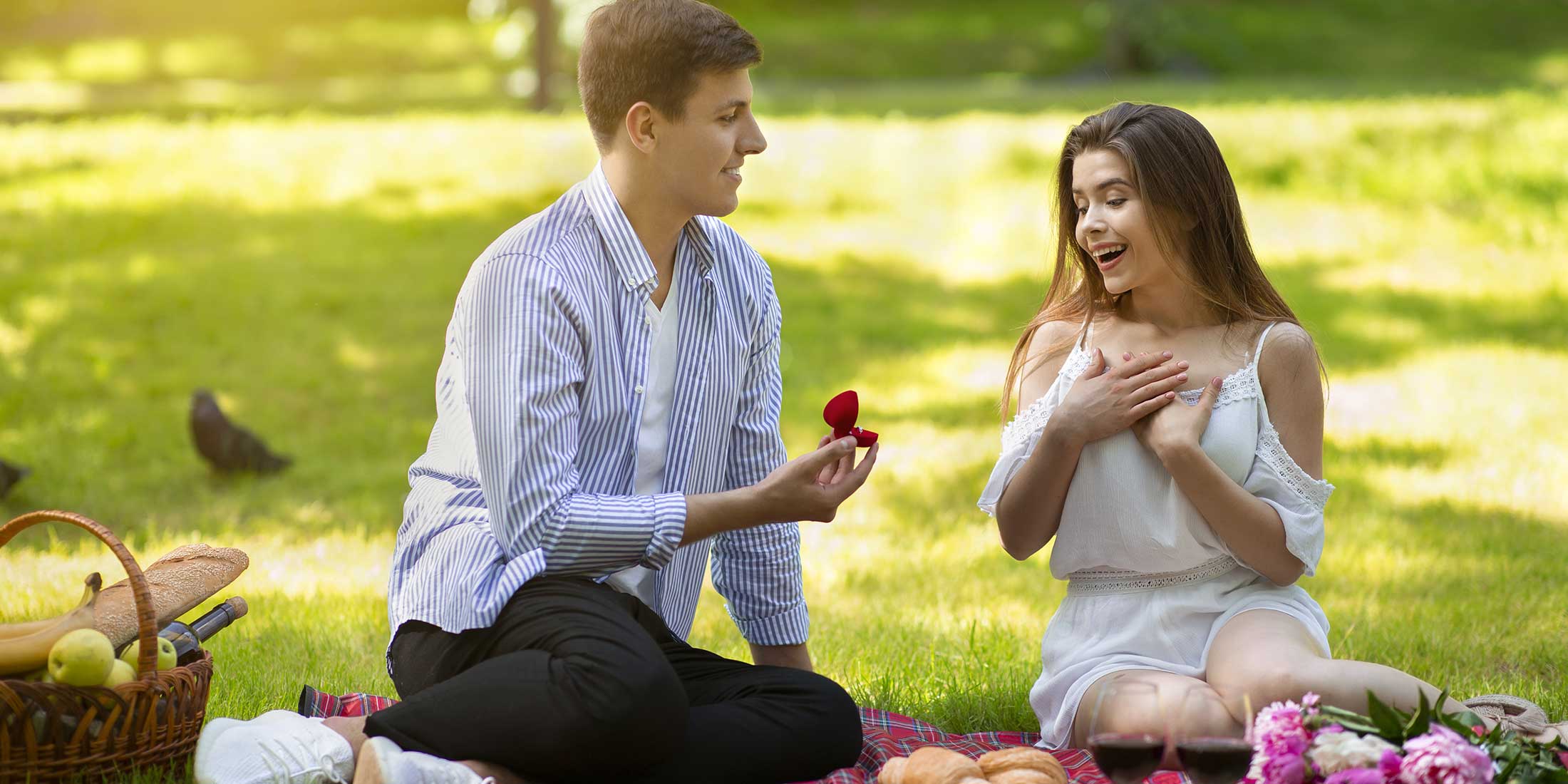 Man proposing to his girlfriend on a picnic