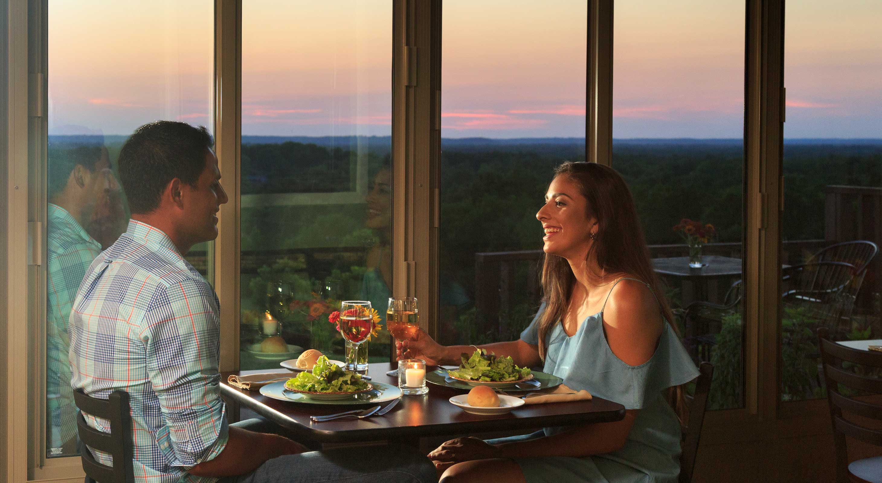 Couple enjoying dinner at sunset with a view at Pleasanton, KS restaurant