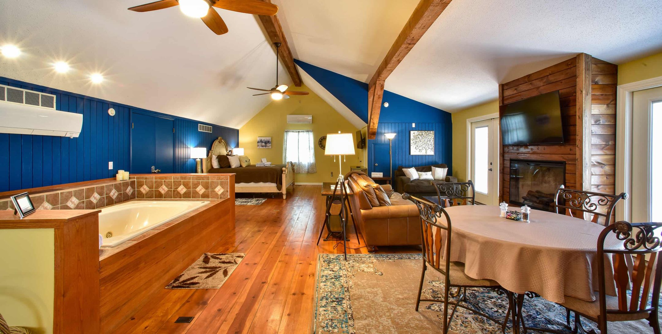 Tuscan Manor Suite bath tub, bed and seating areas