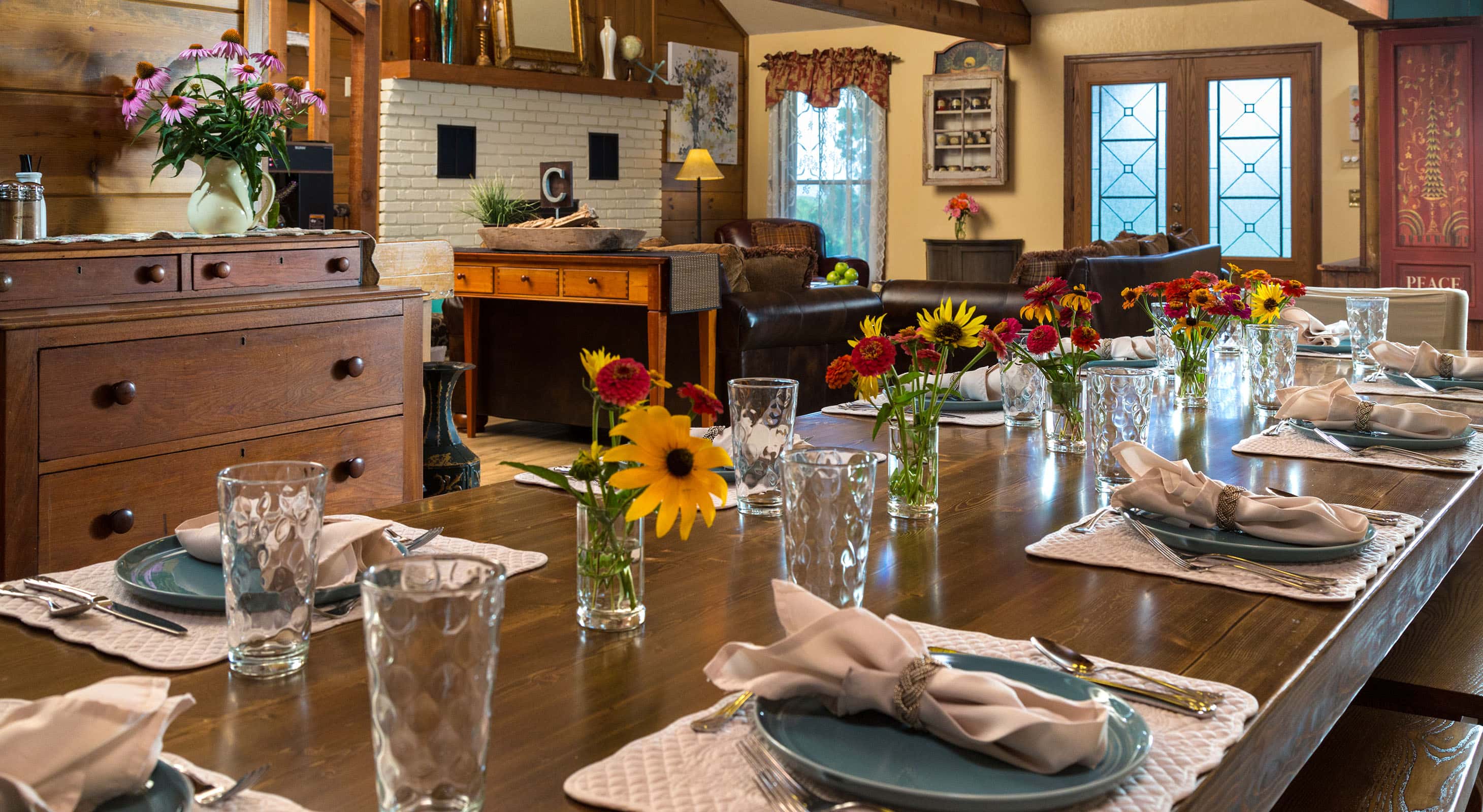 Dining table with small floral centerpieces within rustic lodge