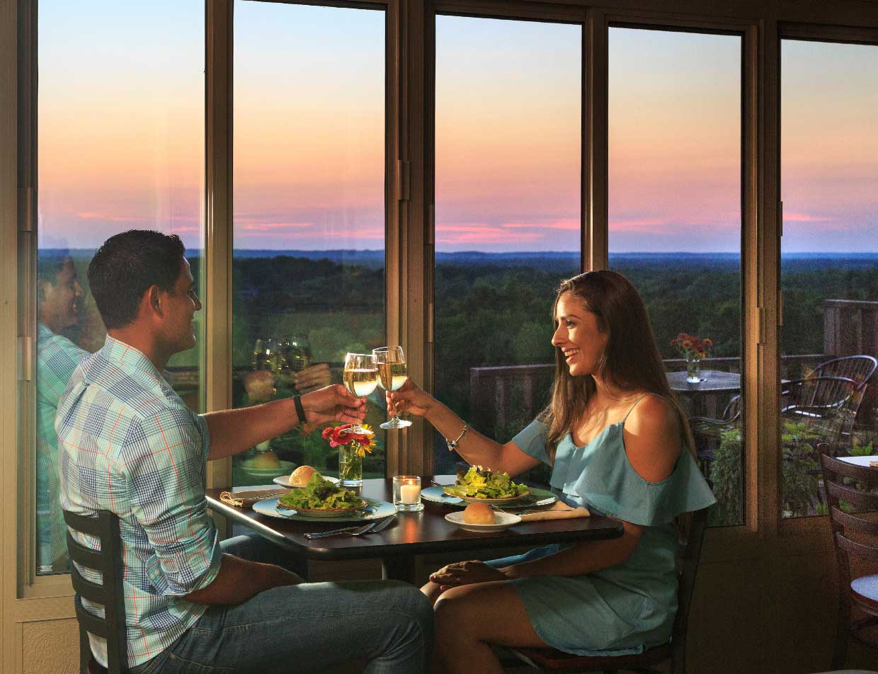 Couple having romantic dinner at sunset