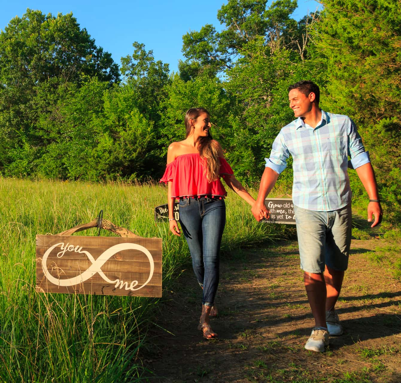 Newlyweds walking in the country with an eternity sign on a Kansas honeymoon