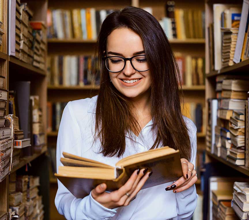 Woman reading a book at the library