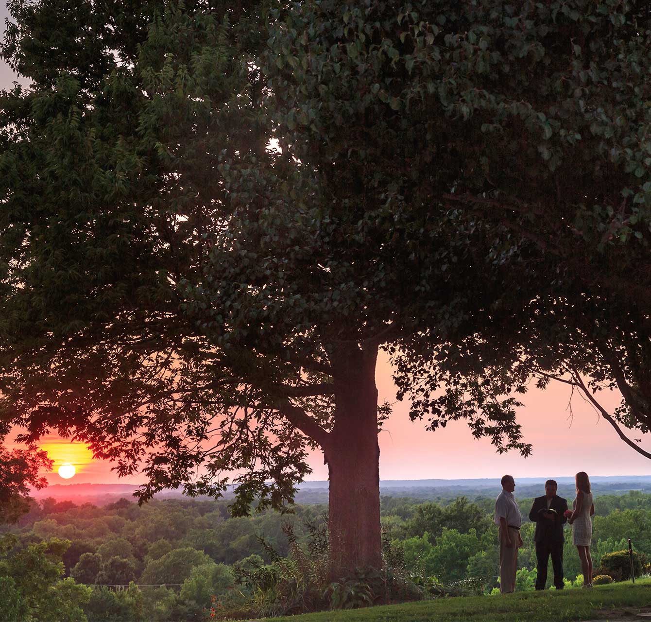 Elopement ceremony in the Pecan Grove at sunset at Kansas wedding venue