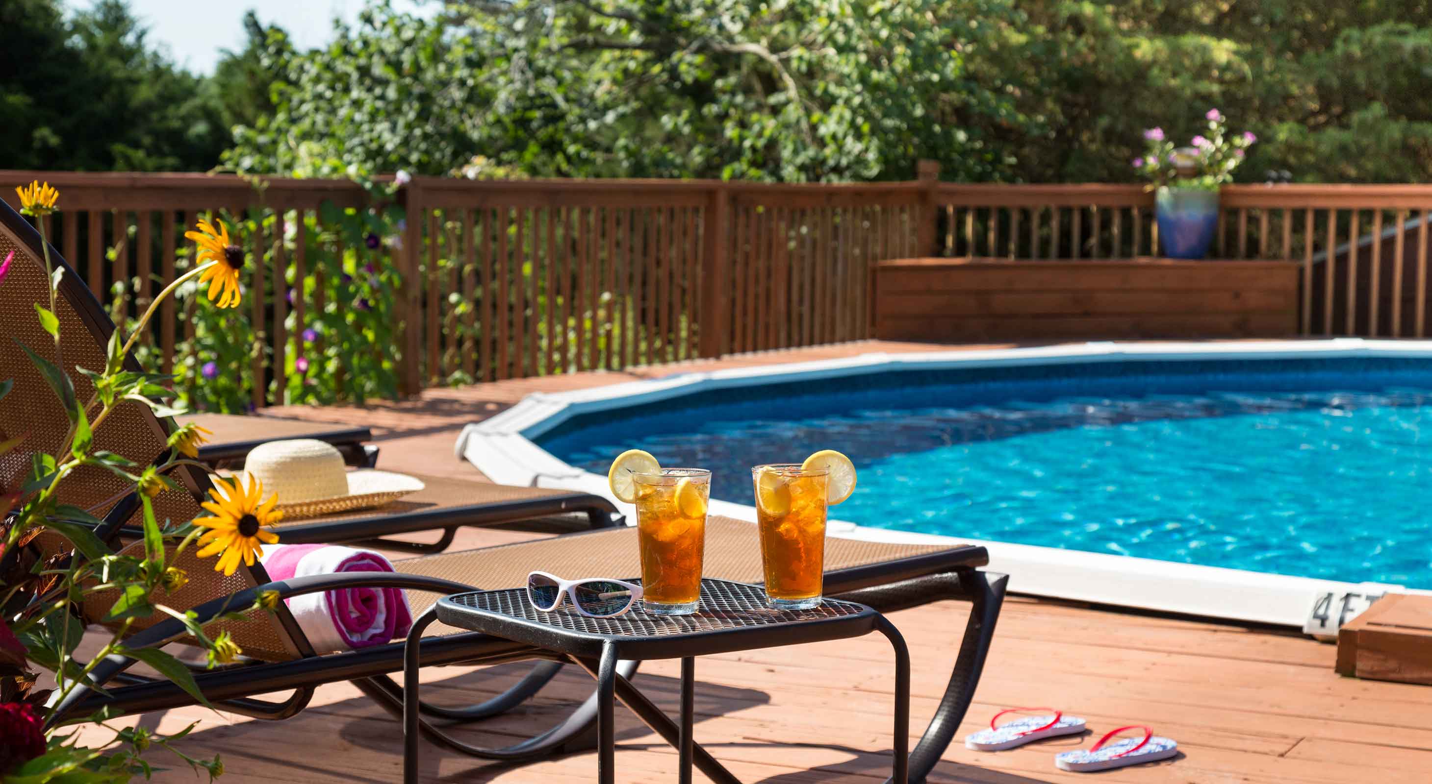 Close up of pool lounge chairs and table