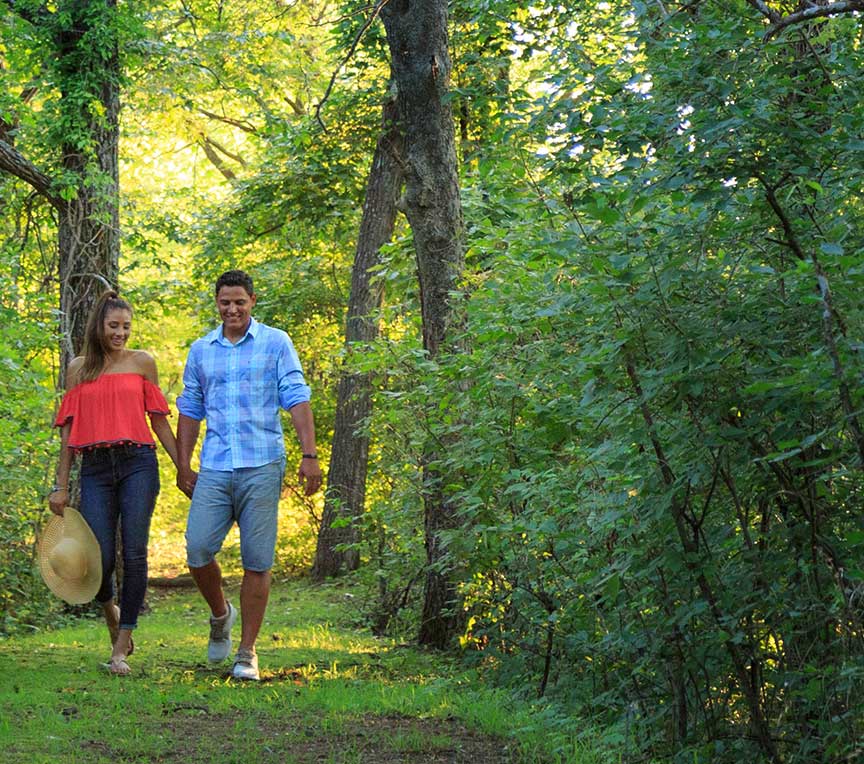 Couple walking on trails in the woods