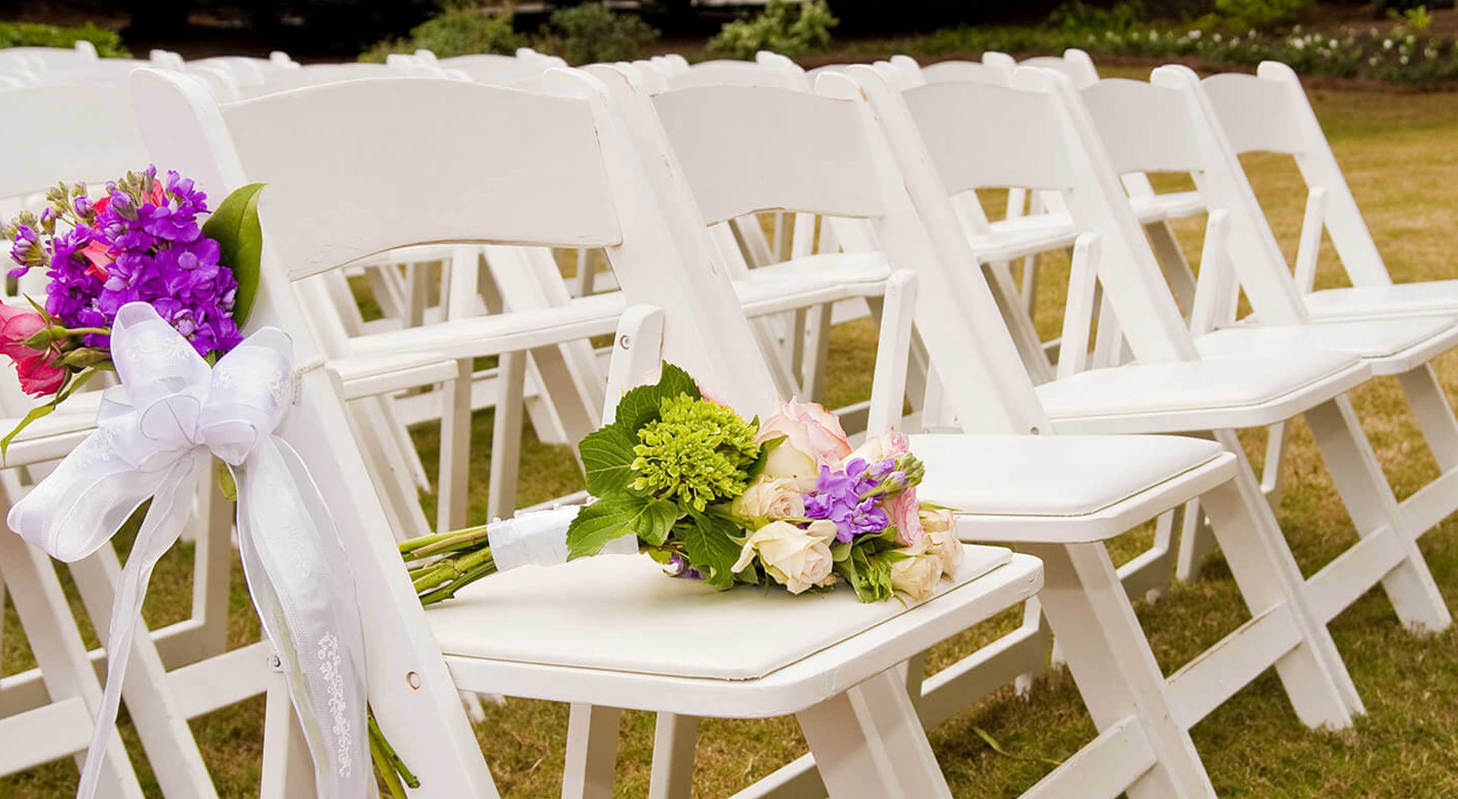 Chairs set up for an outdoor wedding ceremony
