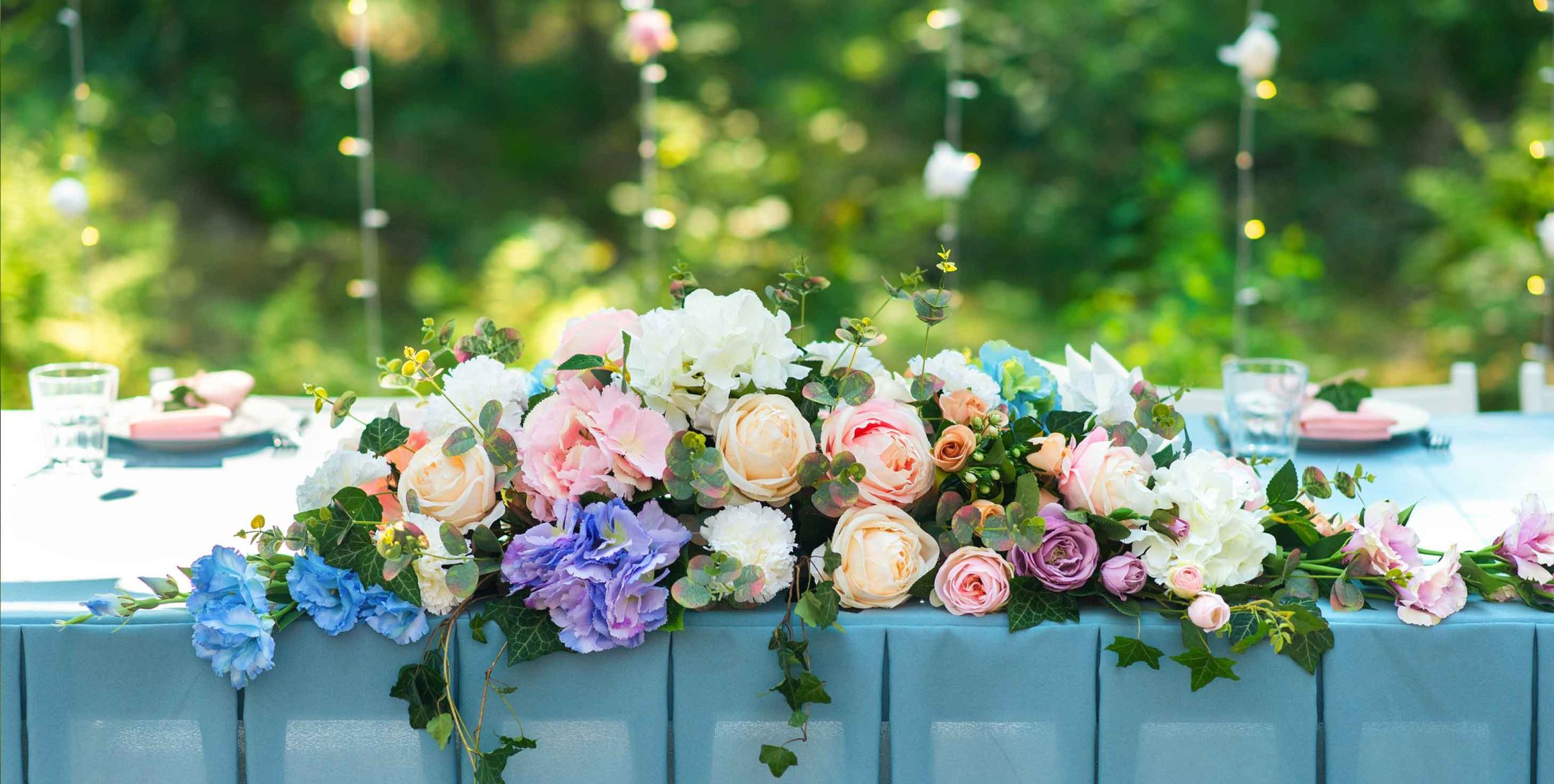 Wedding table décor on a blue tablecloth at wedding venue in Kansas