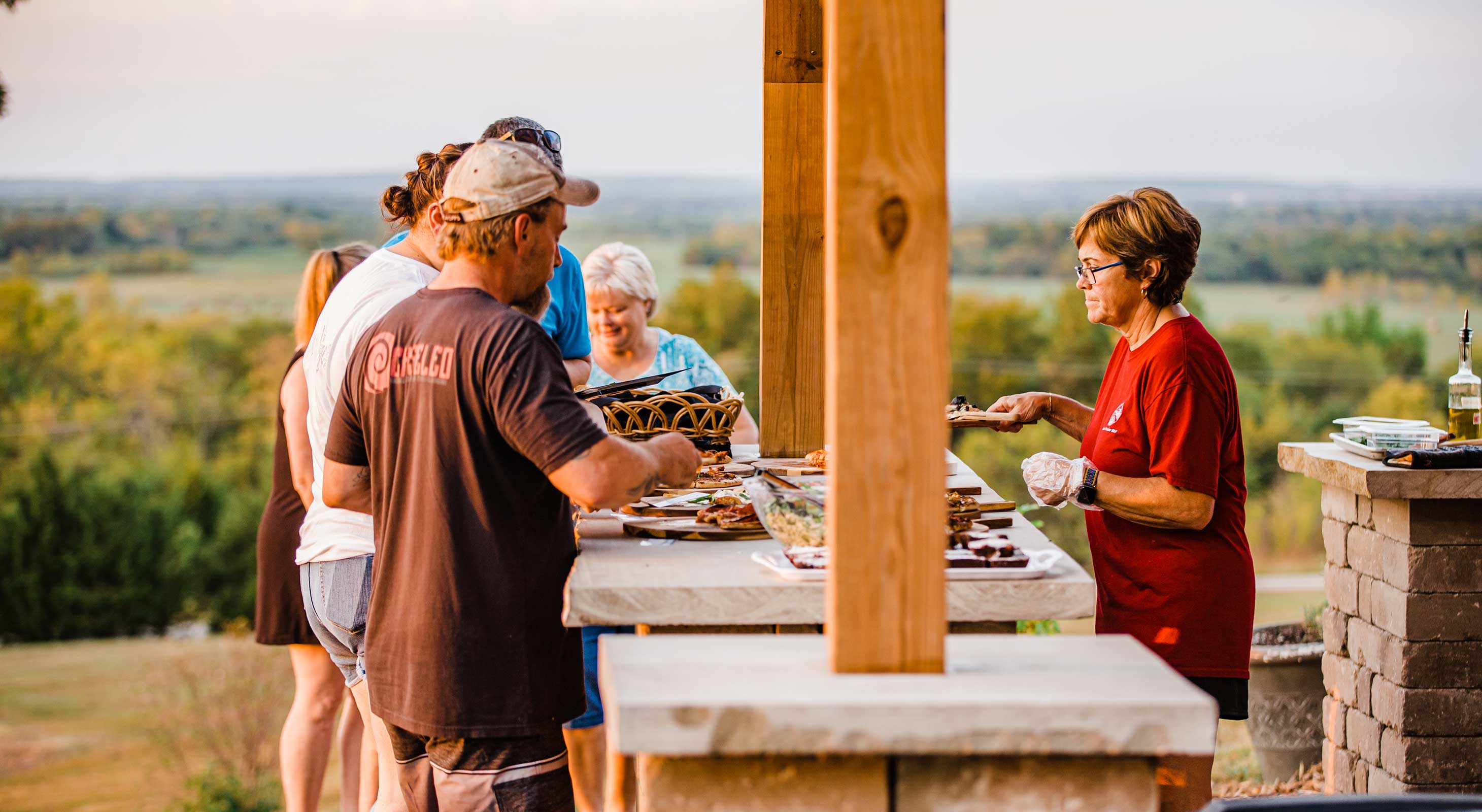 Guests being served wood-fired pizza