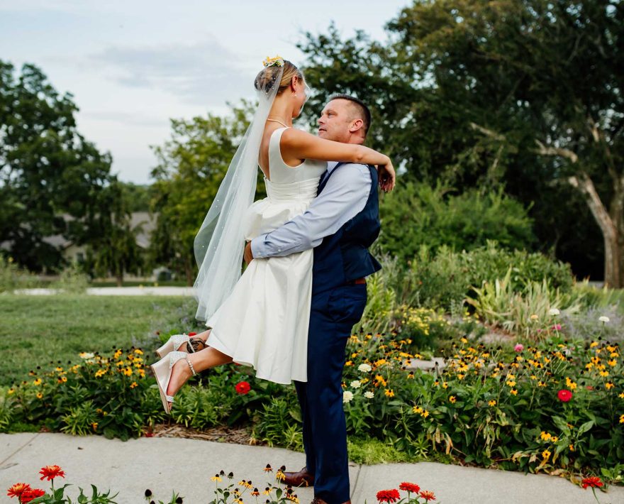 Groom picking up bride