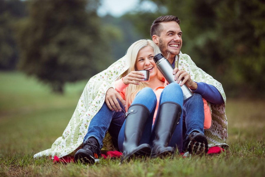 Couple under a cozy blanket on a Midwest honeymoon