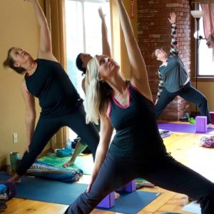 Women practicing yoga at Kansas Yoga Retreat Center