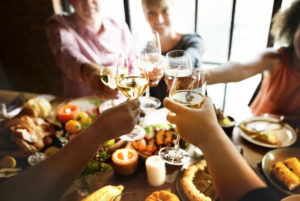 Friends toasting around a seasonal tables spread