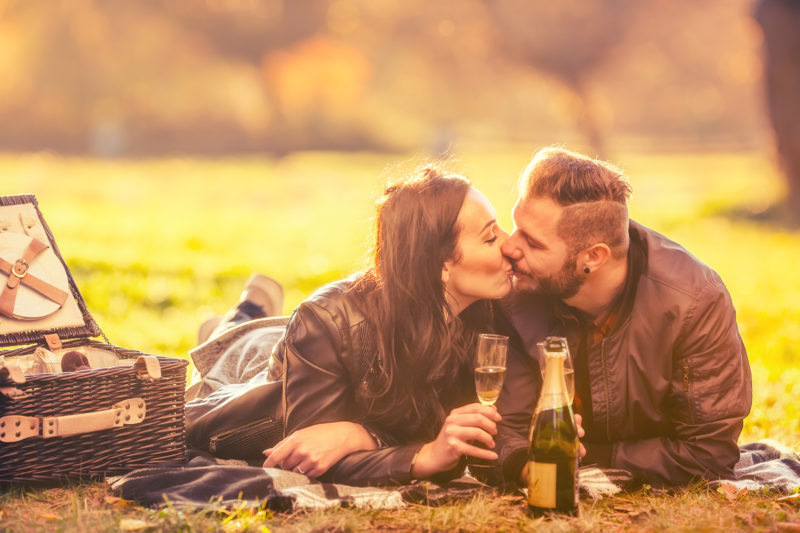 Couple enjoying a romantic autumn picnic at Cedar Crest Lodge.
