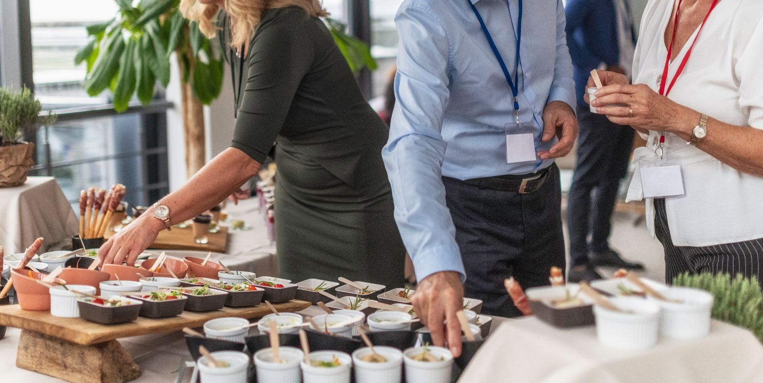 people serving themselves from the buffet table at corporate retreat