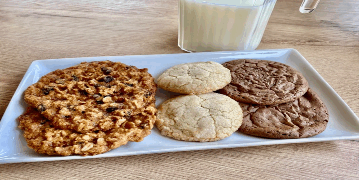 A white rectangle platter with 2 of each of 3 kinds of cookies on it